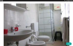 a bathroom with a white toilet and a sink at casa vacanza Regina in Parma