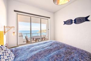 a bedroom with a bed and a view of the ocean at Casa do Mar in Sesimbra