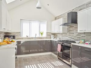 a kitchen with stainless steel appliances and a sink at 88 Anfield Road in Liverpool