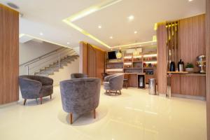 a living room with chairs and a staircase at Hotel Porto Madeira in Porto Velho