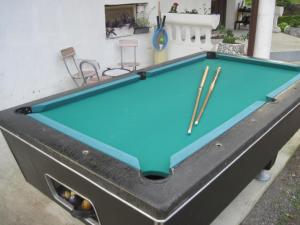 a pool table in front of a house at Apartment Yasica 2 in Izačić
