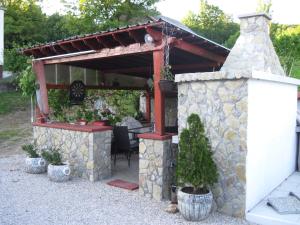 a stone building with a table and some plants at Apartment Yasica 2 in Izačić