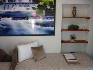 a living room with a couch and a picture on the wall at Room Yasica 2 in Izačić