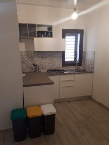 a kitchen with a counter and two trash cans at Casa di Magda in Castellammare del Golfo +64 photos