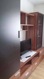 a room with a desk with a television and a cabinet at Apartment Ankica in Seliste Dreznicko