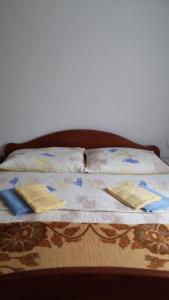 a bed with two blankets and two napkins on it at Apartment Ankica in Seliste Dreznicko