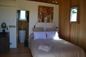 a bedroom with a bed with towels on it at Coup 2 Foudres in Saint-Jean-de-Blaignac