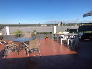 a patio with tables and chairs on a roof at APART SUR II in Termas de Río Hondo