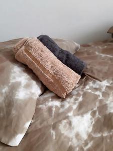 a brown pillow sitting on top of a bed at Inspired by A.C. in Šibenik