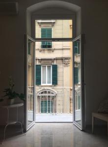 an open door with a view of a building at Queen Chic Apartment in La Spezia