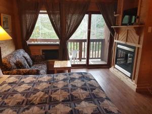 a bedroom with a bed and a couch and a fireplace at Westwind Inn on the Lake in Buckhorn +165 photos