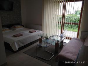 a hotel room with two beds and a glass table at Eleven Pokoje in Gdynia