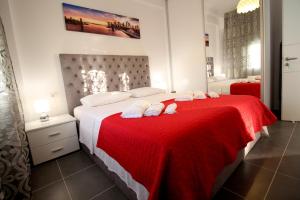 a bedroom with a large bed with a red blanket at Le Gjero luxury villa in Ksamil +59 photos
