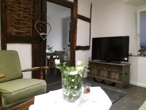 a living room with a vase of flowers on a table at Anna´s Häuschen in Bremm