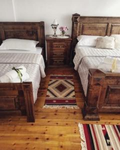 a bedroom with two beds and two night stands at Timo's Guest House in Berat