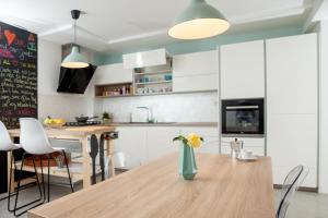 a kitchen with a wooden table with a vase of flowers on it at Hiška pod Krasom in Renče
