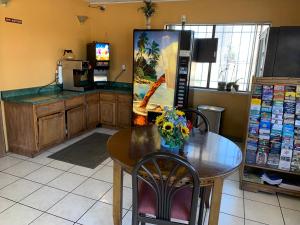 a dining room with a table and a kitchen at Luxury Inn in Albuquerque