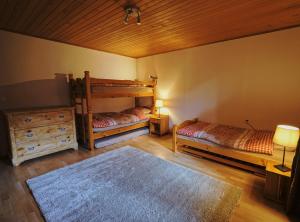 a bedroom with two bunk beds and a rug at Chalet Floriana in Les Diablerets
