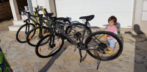 a little girl standing next to a group of bikes at Korak Do Mora in Murvica
