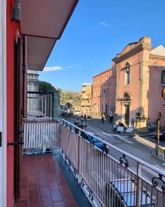 a balcony with a view of a city street at Sweet Home in Francavilla di Sicilia