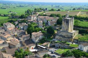 an old village with a church and a tower at Coup 2 Foudres in Saint-Jean-de-Blaignac