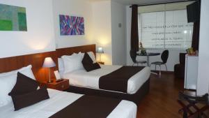 Een bed of bedden in een kamer bij Hotel Casa Galvez