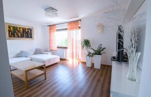 a living room with a couch and a table at Apartmaji Baron in Bled