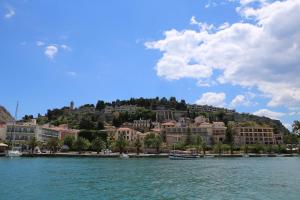 a view of a resort from the water with buildings at Old Town Apartment next to Seafront Promenade in Nafplio