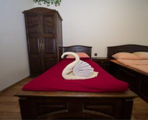 a bedroom with two beds and a red blanket at Гурме хаус in Gabrovo