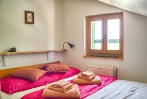 a bedroom with two beds with towels on them at STONE HOUSE VLASTA in Drniš