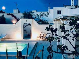 a villa with a swimming pool at night at Oltre gli Ulivi in Ostuni