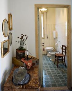 a bathroom with a toilet and a table in a room at B&B Lady Cocca in Savio di Ravenna