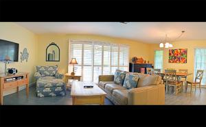 ein Wohnzimmer mit einem Sofa und einem Tisch in der Unterkunft Crescent Beach 1011 #3 in Sarasota