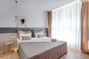 Postel nebo postele na pokoji v ubytování Apartments HUGO 2