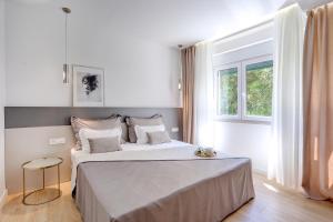 Postel nebo postele na pokoji v ubytování Apartments HUGO 2