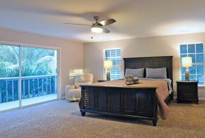 a bedroom with a bed and a large window at Shell Beach Home 209 in Sarasota +30 photos