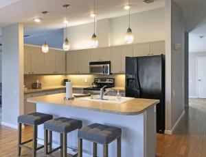 a kitchen with a large island with bar stools at Shell Beach Home 209 in Sarasota