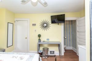 a bedroom with a bed and a tv on the wall at Ambiance By The Falls B&B in Niagara Falls