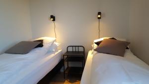 two beds sitting next to each other in a room at Gíslaholt in Borgarnes