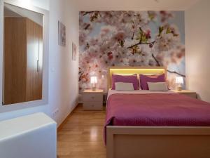 a bedroom with a bed and a flower wall at Onyx City Center Apartment in Heraklio