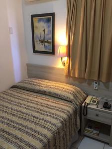 Postel nebo postele na pokoji v ubytování Ideal Praia Hotel