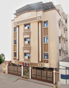 a large apartment building with a balcony at Bluemoon Grand in Bangalore