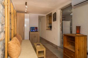 a living room with a couch and a refrigerator at Apartments Mirian in Petrovac na Moru