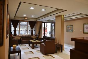 a living room with a couch and a table at 24 Seven Boutique Hotel in Malia