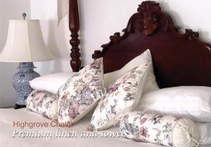 a bedroom with a bed with pillows and a lamp at Highgrove in Promised Land