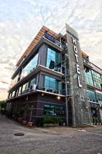 a building with a sign on the side of it at Mangga Boutique Hotel in Seri Kembangan