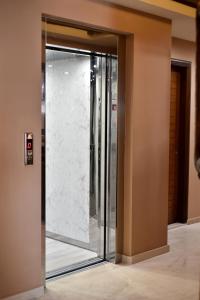 a glass elevator in a building at 24 Seven Boutique Hotel in Malia