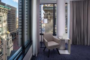 a balcony with a chair and a laptop on a table at Hyatt Centric Faneuil Hall Boston in Boston