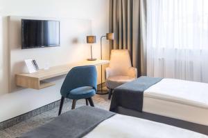 Postel nebo postele na pokoji v ubytování Ramada by Wyndham Flensburg City + 37 fotografií