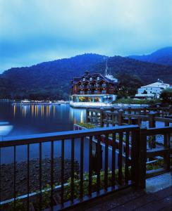 a large building on the water near a dock at The Richforest Hotel- Sun Moon Lake in Yuchi